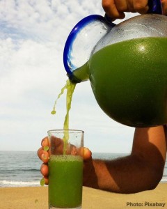 green juice poured into a glass, raw food eating